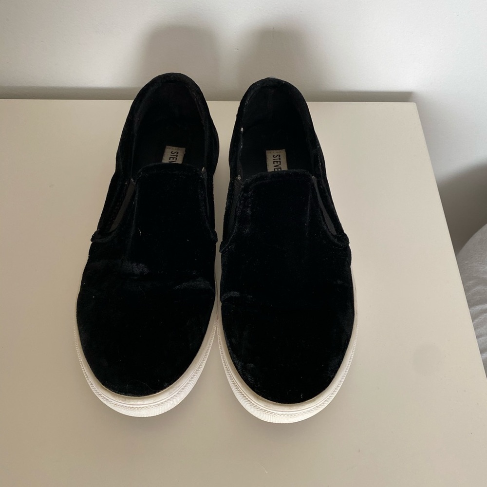 Black suede slip on sneakers from Steve Madden.
